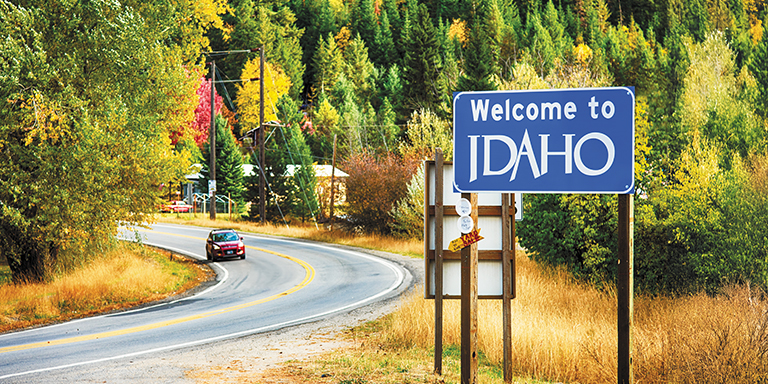 A sign denoting the border of Montana welcoming travelers to the state of Idaho.