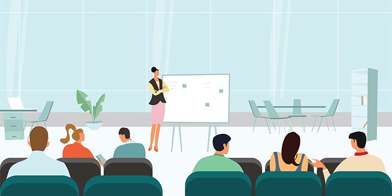 Instructor talking in front of a classroom