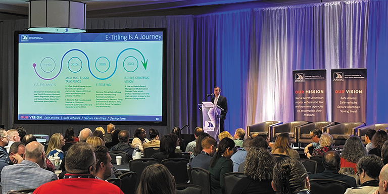 Photo of the e-titling conference showing a presenter on stage