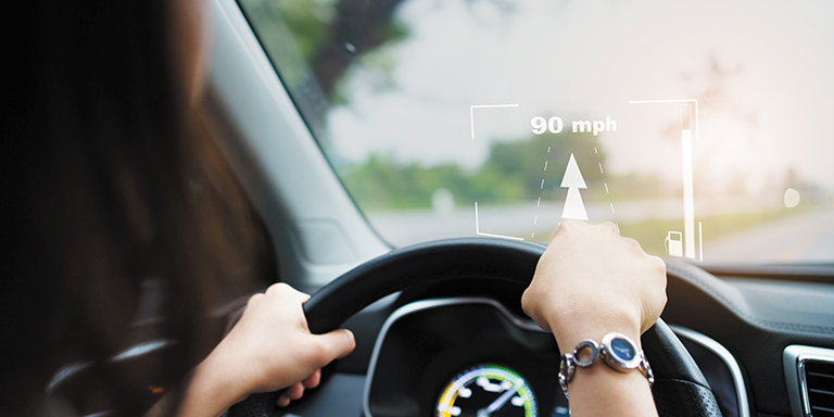Woman driving with HUD in windshield